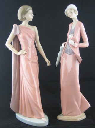 A Nao figure of a lady with parasol and kitten 12" and 1 other of a walking lady 12"
