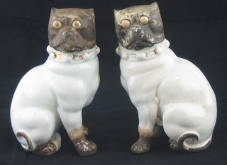 A pair of 19th Century Continental porcelain figures of seated Pugs 4"