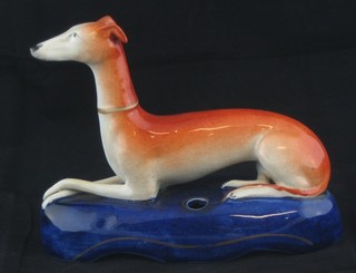 A 19th Century Staffordshire pen rest in the form of a reclining grey hound 6"