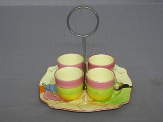 A Clarice Cliff Fantasque pattern egg cup stand together with 4 Applique pattern egg cups (1 chipped)