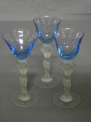 3 blue tinted wine glasses with clear glass stems in the form of standing naked ladies