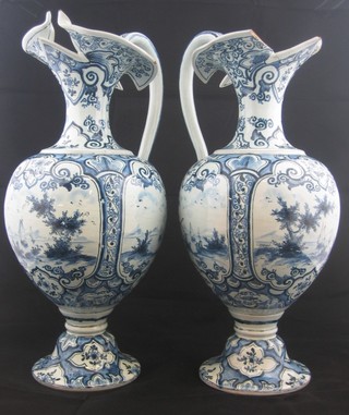 A pair of Delf blue and white ewers (1 with spout f and 1 chipped) decorated Windmills, base marked A 12" ILLUSTRATED