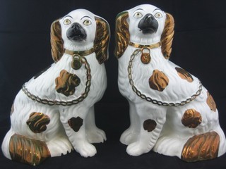 A pair of 19th Century figures of seated Staffordshire Spaniels 9"