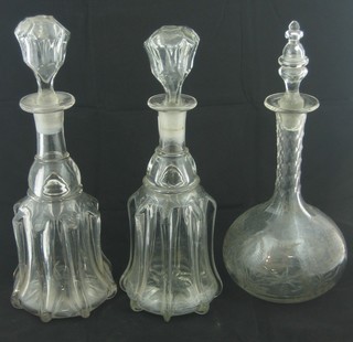 A pair of 19th Century bell shaped glass decanters and stopper and a club shaped decanter and stopper