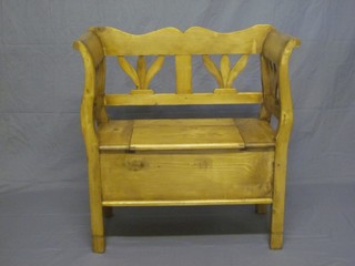 A Continental stripped and polished pine settle with hinged lid 34"