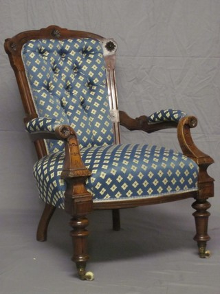A Victorian show frame mahogany open arm chair upholstered in blue material and raised on turned supports