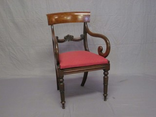 A 19th Century mahogany bar back carver chair with carved mid rail and upholstered drop in seat, raised on turned supports