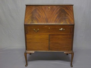 An Edwardian inlaid mahogany bureau, the fall front revealing a well fitted interior above 1 long drawer, the base fitted cupboards enclosed by panelled doors, raised on cabriole supports 31"