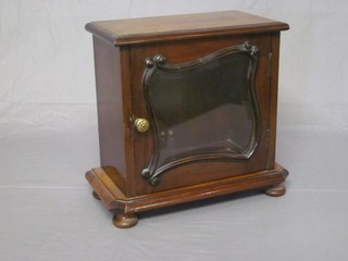 An Edwardian table top display cabinet enclosed by a glazed panelled door, raised on bun feet 12"