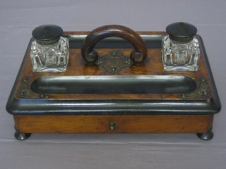 A Victorian walnut ink stand, fitted 2 cut glass bottles and 2 pen recepticals, the base fitted a drawer and raised on bun feet 14"