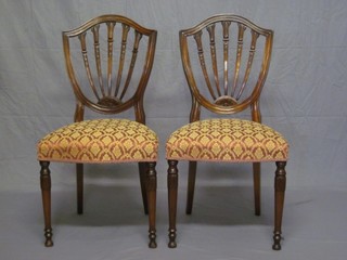 A set of 8 mahogany Hepplewhite style dining chairs with upholstered seats, raised on turned supports