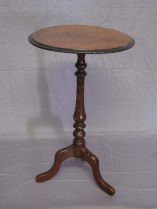 A Victorian circular figured walnut wine table raised on a turned column and tripod base 17"