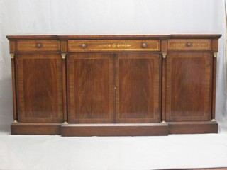A handsome Victorian style mahogany break front sideboard, fitted 1 long drawer flanked by 2 short drawers above a double cupboard flanked by a pair of cupboards with columns to the sides, raised on a platform base 77"