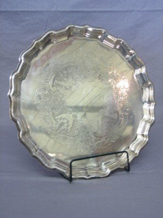 A circular engraved silver plated salver with bracketed border 14"