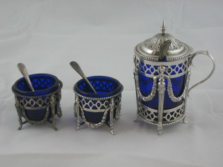 A 3 piece Adams style pierced metal condiment set with mustard pot and 2 salts with blue glass liners