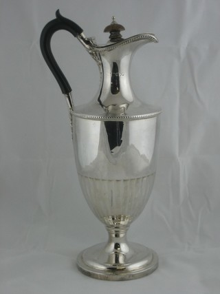 A Victorian cylindrical silver hotwater jug with demi-reeded decoration, London 1884 (marks rubbed) 16" ILLUSTRATED