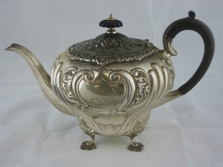 An Edwardian circular embossed silver teapot, raised on 4 hoof feet, London 1906 23 ozs