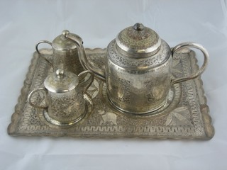 An Eastern silver plated 4 piece tea service with tray, teapot, cream jug and sugar bowl