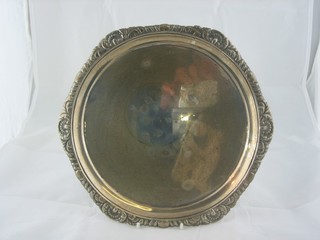 A circular George III silver salver with bracketed border, raised on 4 panel feet, London 1781, 20 ozs  ILLUSTRATED