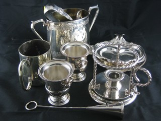 An oval silver plated twin handled sugar bowl, 3 silver plated  dishes, a pair of silver plated sugar tongs, a chamber stick etc