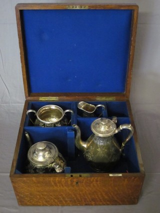 A Victorian engraved silver plated 4 piece tea/coffee service comprising teapot, coffee pot, twin handled sugar bowl and  cream jug by Elkington, contained in an oak case