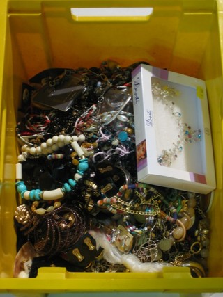 A yellow plastic crate containing a collection of costume  jewellery