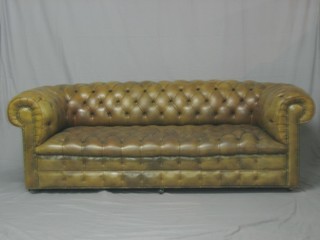 A mahogany framed Chesterfield upholstered in brown buttoned  back leather 84"