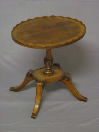 A Georgian style oval yew wine table, raised on a turned column  with square base and splayed feet 17"