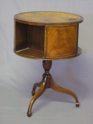 A Georgian style circular mahogany revolving bookcase table with inset tooled leather writing surface, raised on a turned  column and tripod base 20"