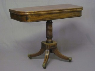 A Georgian mahogany D shaped card table, raised on a turned column with platform base and outswept supports ending in brass  caps and castors 36"