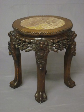 A circular carved Oriental Padouk jardiniere stand with pink  veined marble top 16"