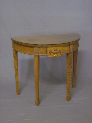 A Georgian style mahogany carved demi-lune side table with  arcaded decoration, raised on square turned supports ending in  spade feet 33"