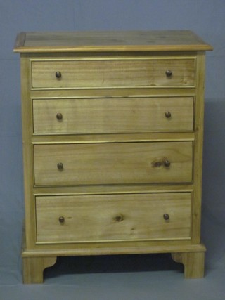 A Victorian style bleached mahogany chest of 4 long graduated drawers with tore handles, raised on bracket feet 29 1/2"