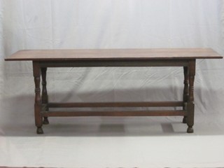 An 18th Century rectangular oak refectory base raised on turned  and block supports with rail stretchers, having a later top 73"