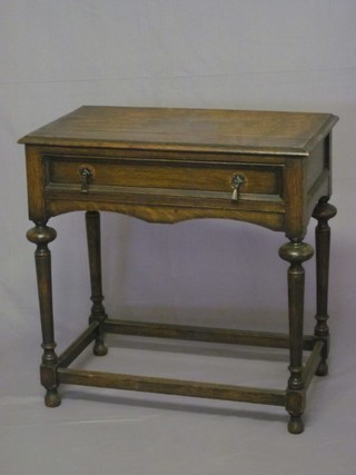 A Jacobean style oak side table, fitted a drawer and raised on turned and block supports with box framed stretcher 30"