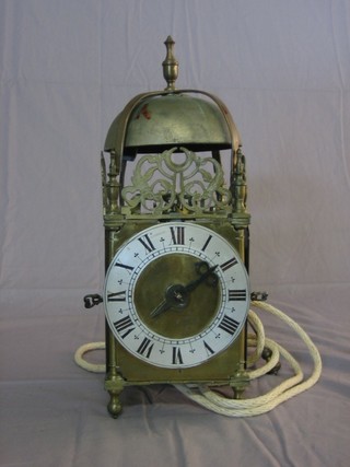 A reproduction 17th Century style brass striking hanging lantern clock with verges escapement, 5 1/2" silvered dial and Roman  numerals