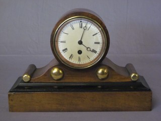 A 19th Century 8 day mantel clock with enamelled dial and Roman numerals contained in an arch shaped case