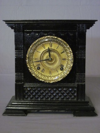 An American 8 day striking mantel clock with gilt dial contained in a black painted case 11"