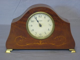 An Edwardian 8 day mantel clock with paper dial and Arabic numerals, contained in an arched inlaid mahogany case