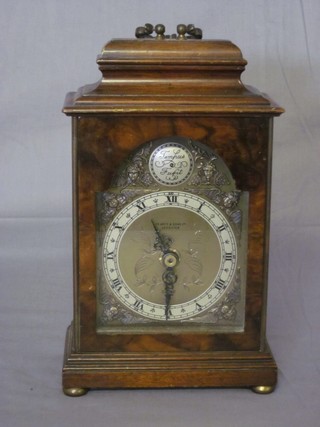 An Elliott, Georgian style miniature bracket clock, the arch  shaped dial contained in a walnut case and with battery operated  movement ILLUSTRATED