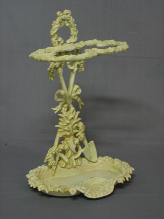 A Victorian style white painted cast iron umbrella stand decorated garlands and trophies 24"