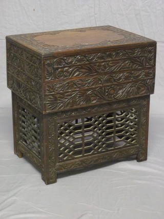 An Eastern carved hardwood cabinet/table with hinged lid, fitted numerous compartments and 2 drawers 21"