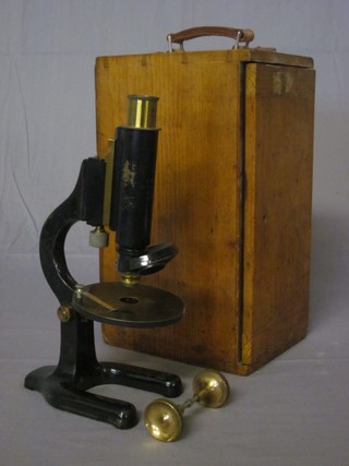 A brass single draw microscope by C Baker no.6173, boxed