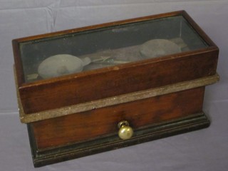 A curious pair of scales contained in a rectangular mahogany case  38"