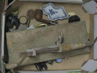 A box containing a collection of curios including a cow cluster teet trimmer etc