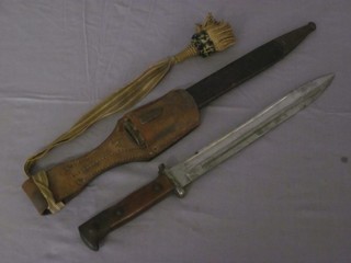 A German WWI bayonet with single blade marked Weyersberg  Solingen complete with scabbard and dress knot