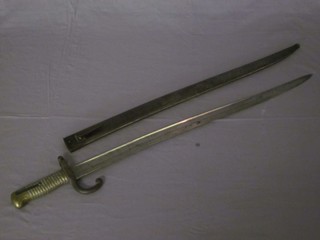 A chassepot bayonet with brass grip and metal scabbard and  unmarked blade