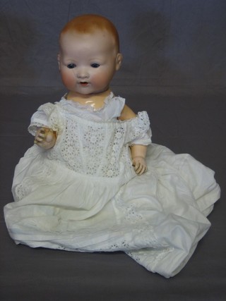 An Armand Marseille porcelain headed doll with open and  shutting eyes, open mouth, the head incised AM German 351/7K