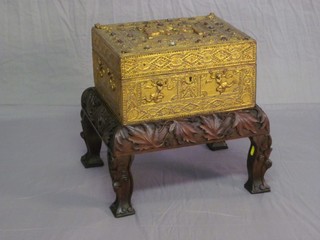 A hardwood trinket box with hinged lid set semi-precious stones, raised on a heavily carved stand with cabriole supports 14"