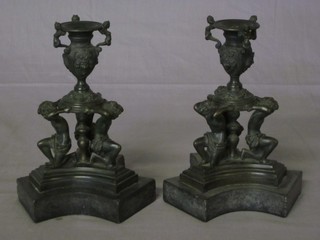 A pair of Victorian bronze candlesticks supported by figures and raised on shaped marble bases, the base marked Fabbriga M  Guggenheim Venezia B, 8"